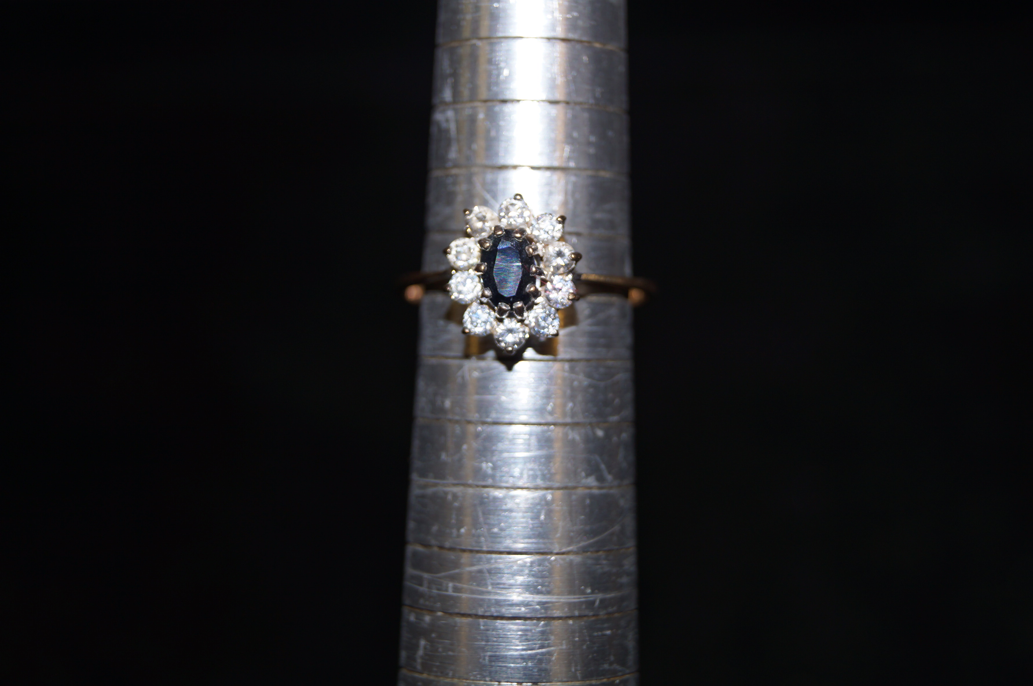 9ct Gold ring set with central blue stone surround