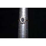 9ct Gold ring set with central blue stone surround