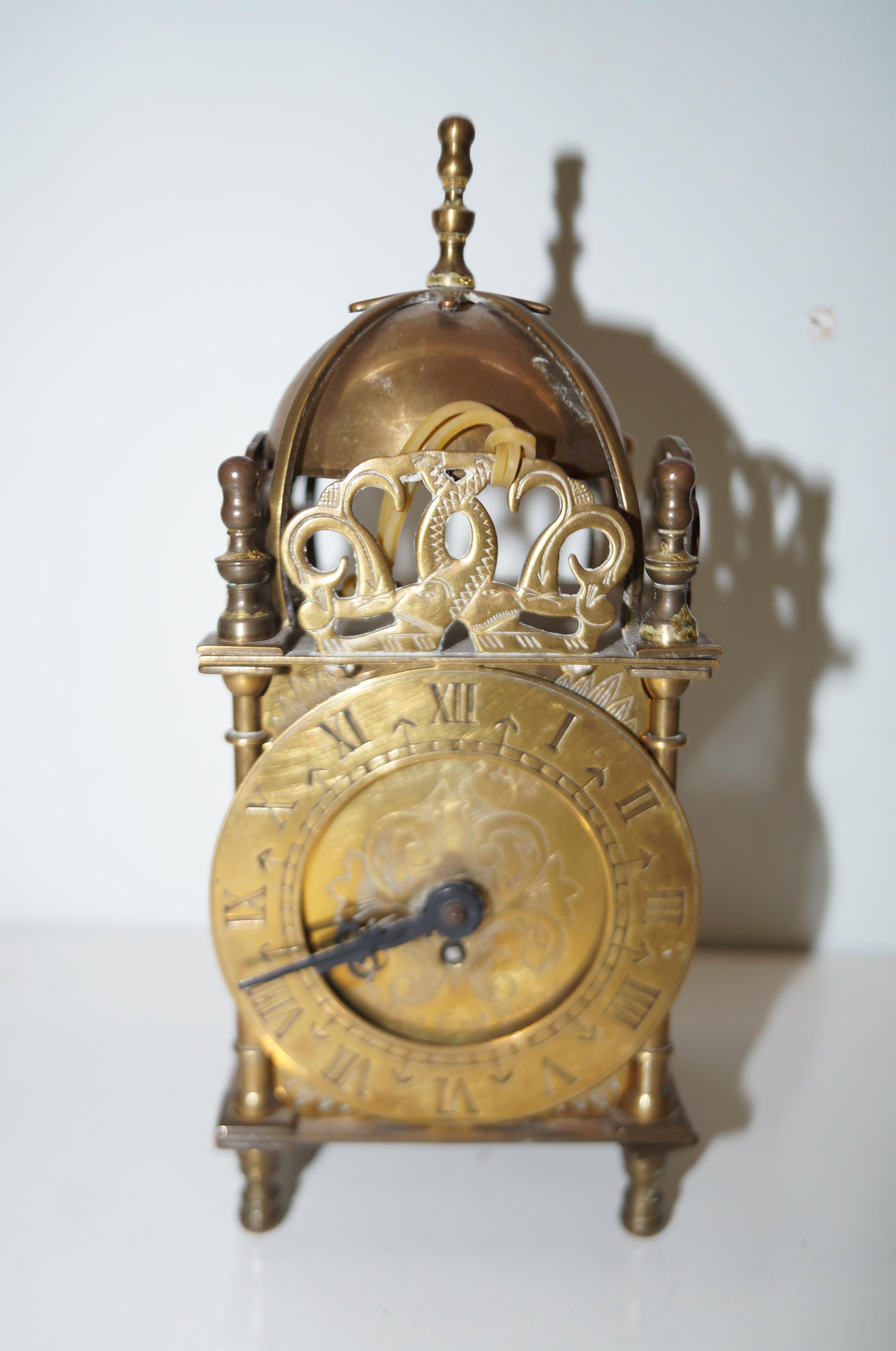 Smiths 8 day brass lantern clock. Height 19cm.