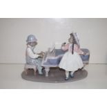 Lladro figure of a boy playing a piano with a girl