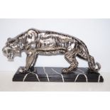 Silver effect figure of a tiger on faux marble bas