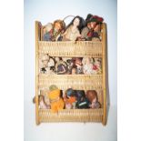 Wicker shelf with a collection of vintage dolls