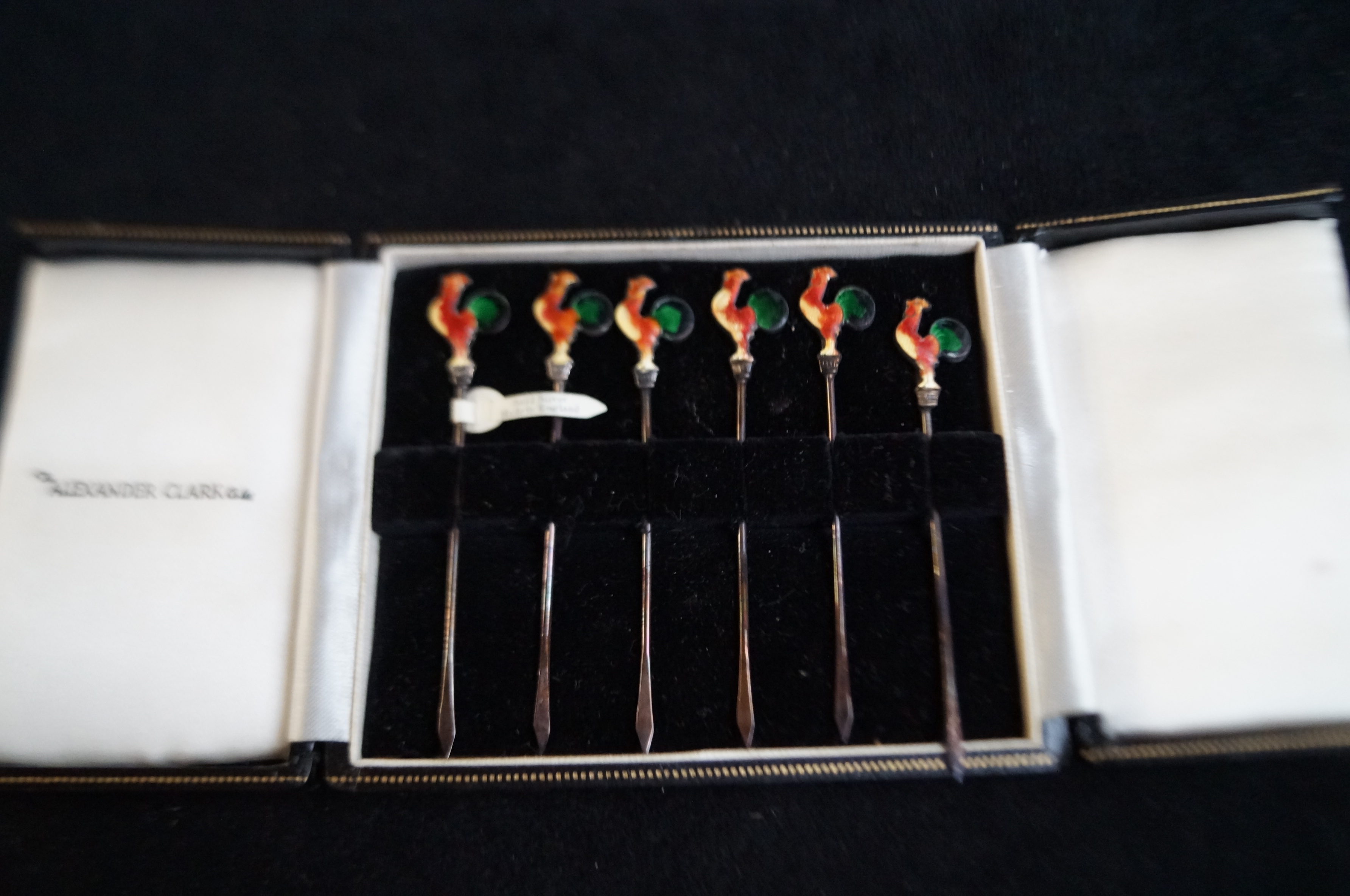 Cased set of 6 silver and enamel cocktail stick with cockerel terminals by Alexandra clarke