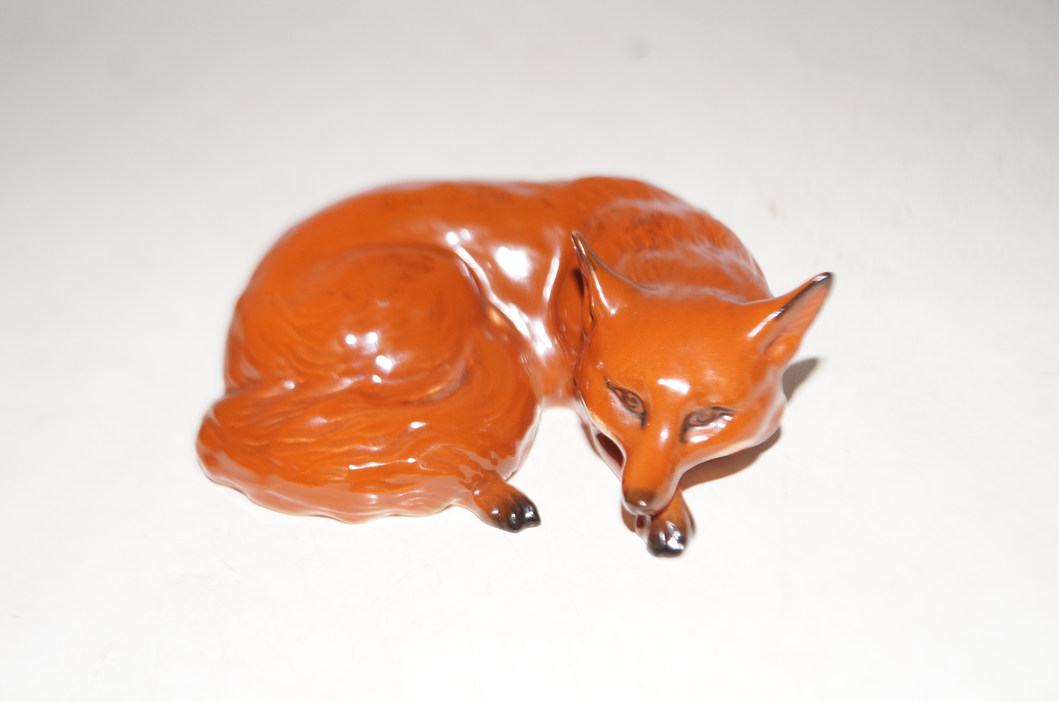 Beswick fox curled up lying down