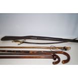 4 Walking sticks, a wooden gun stock & sword