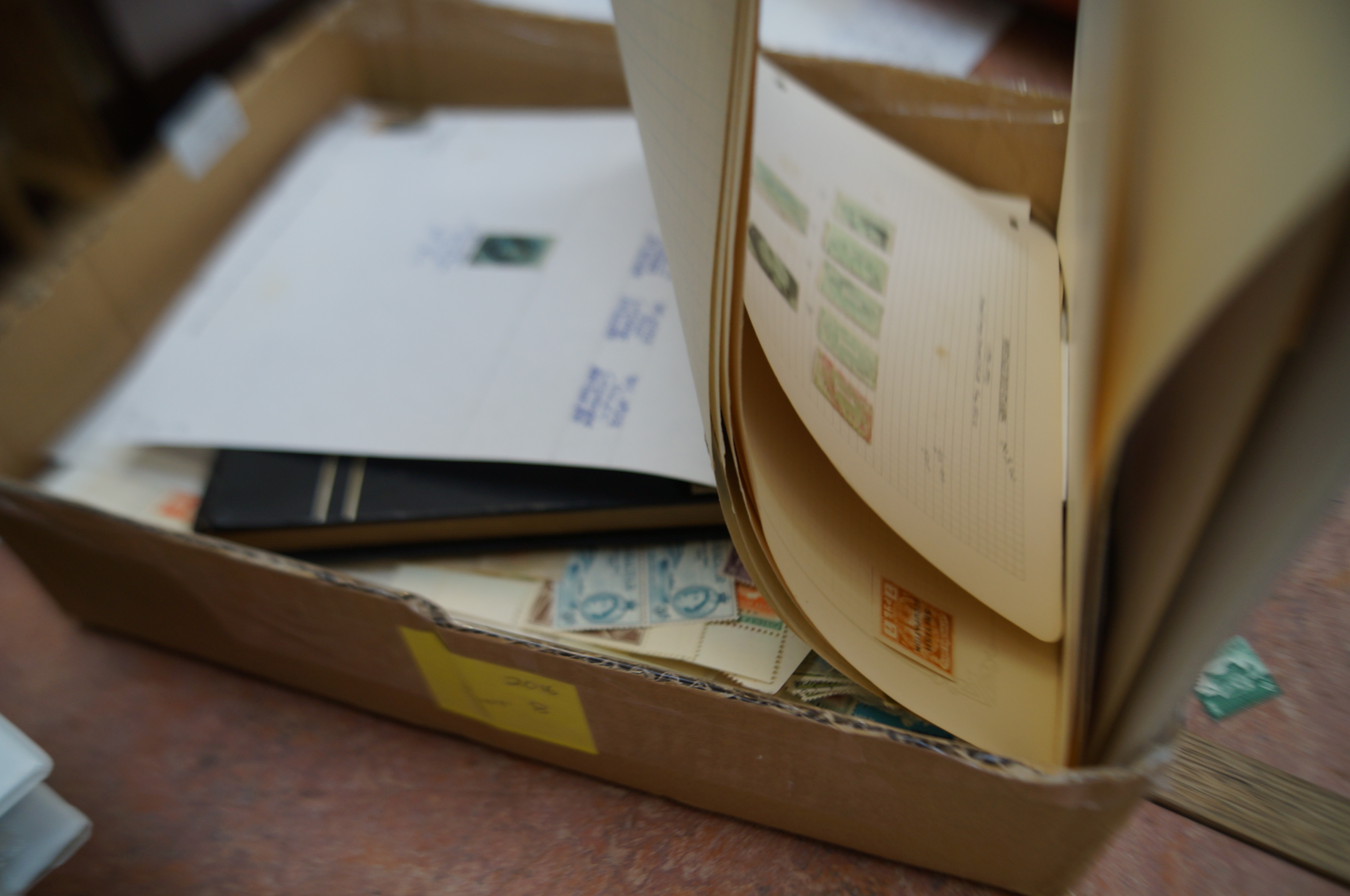 A box containing a large hoarde of stamps. Include