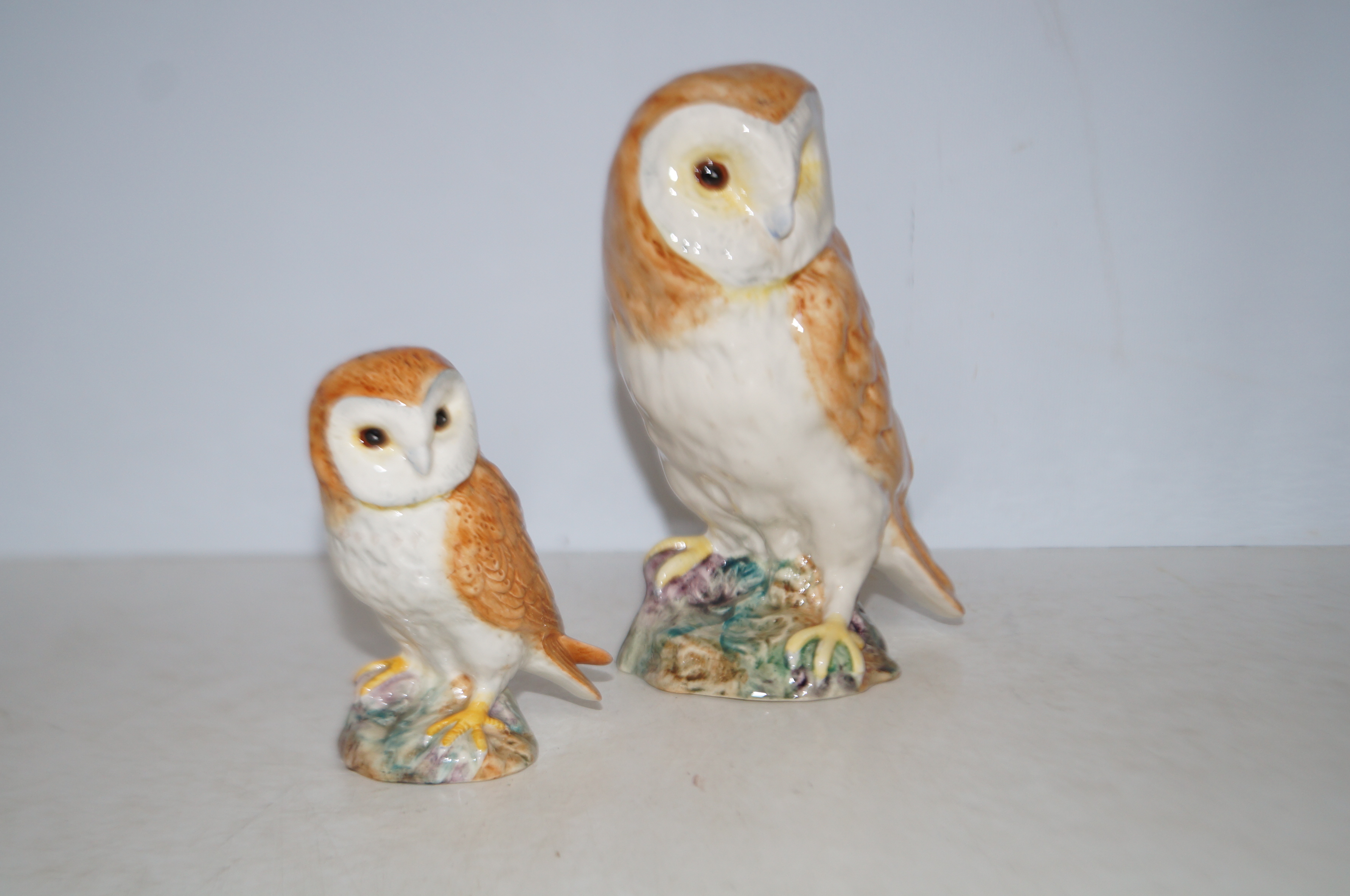 Beswick barn owl together with a small barn owl Ta