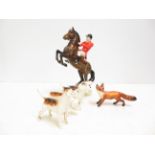 Beswick rearing horse with four Beswick hounds and