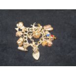 9ct Gold charm bracelet including 1 18ct cuckoo ch