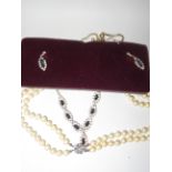 Simulated pearl necklace with silver clasp togethe