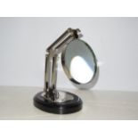 Chrome magnifying glass on wooden base