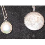 Silver locket together with a half cut mother of p