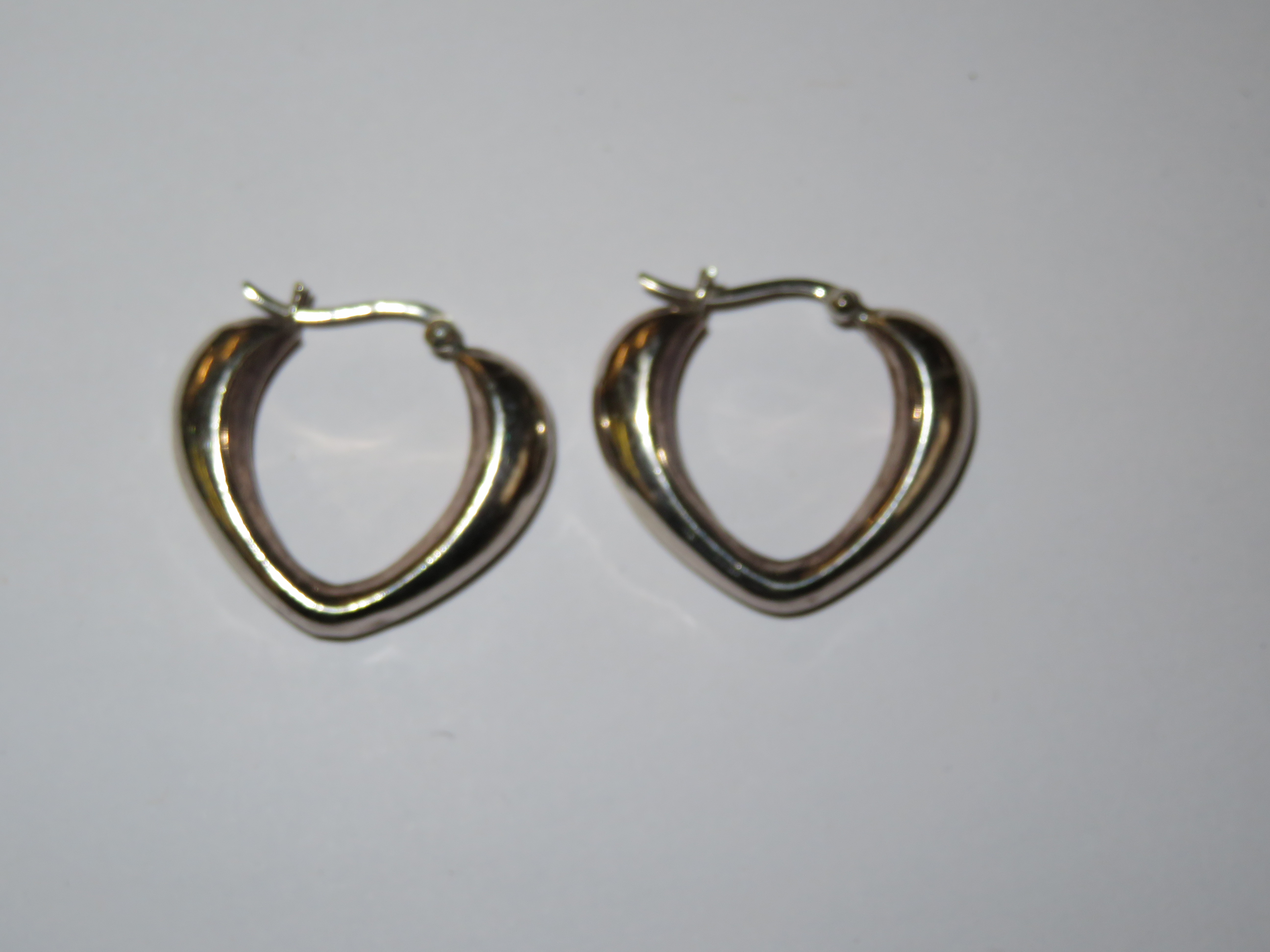 Pair of silver heart shaped earrings