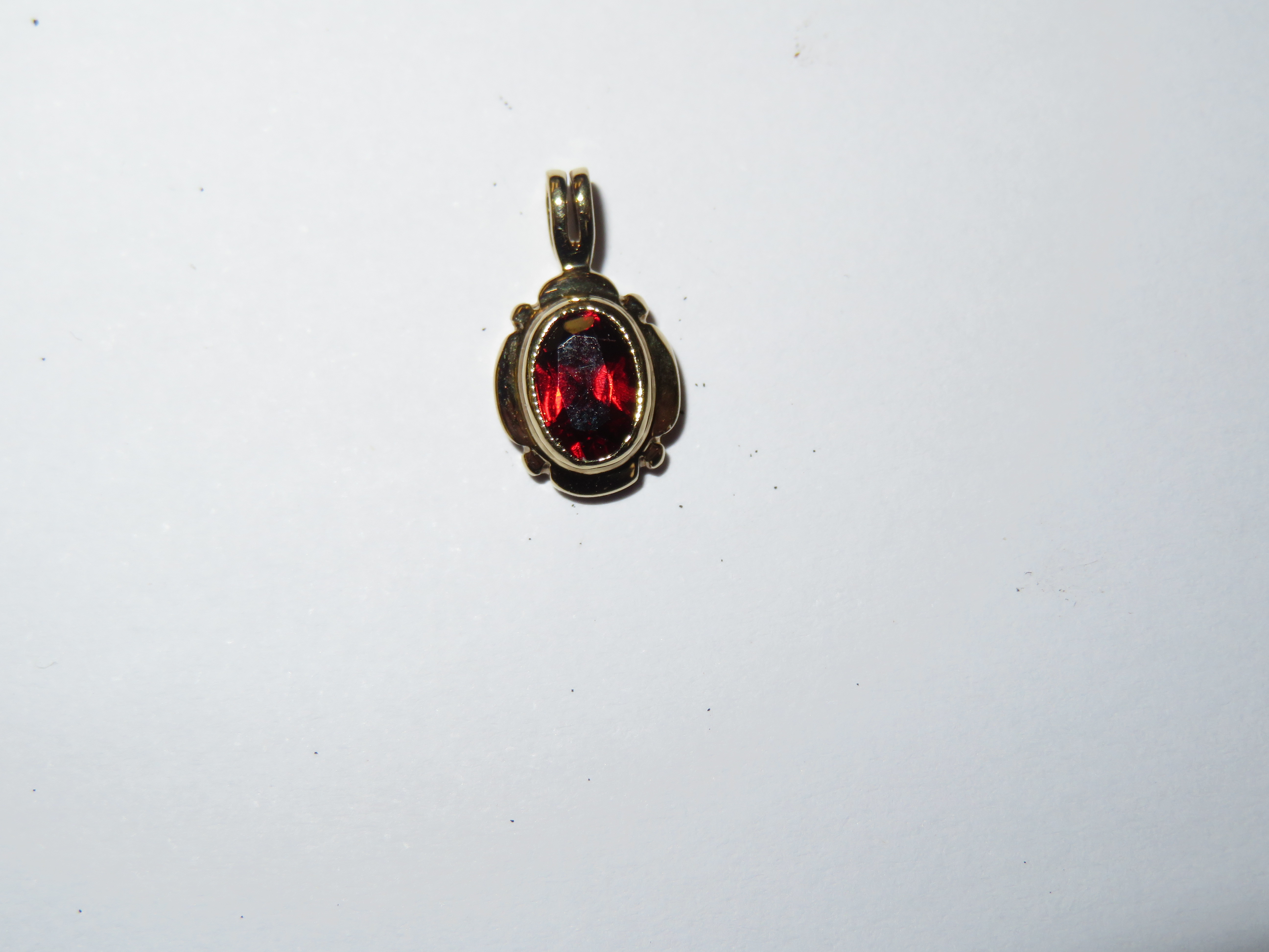 9ct Gold pendant set with red stone