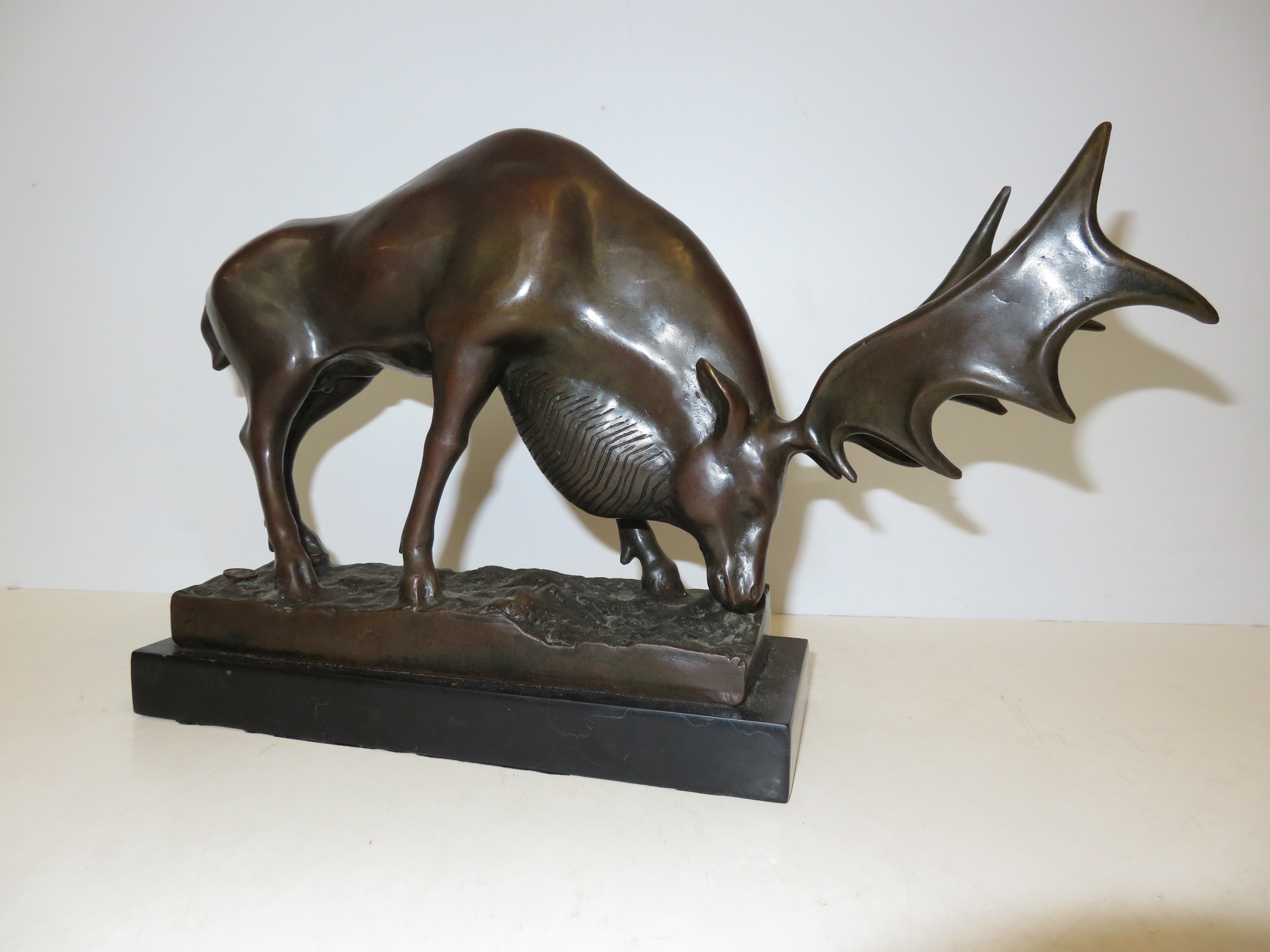 Bronze figure of a moose on plinth Length 40 cm