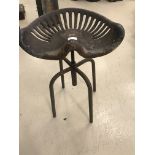 An antique tractor seat industrial stool