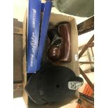 A box of various bygones; scales, bottles, clocks, police hat,