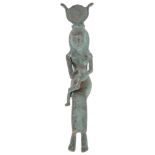 An Egyptian Figure: Bronze, of Isis and Horus, with green patination,