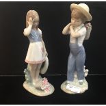 Two Lladro figures: a boy and girl with flowers