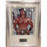 A framed and glazed signed photograph of Arnold Schwarzenegger with COA