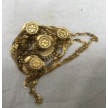 An Indian gold necklace and buttons on chain for Lucknow