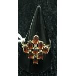 A 10k garnet and diamond ring