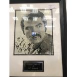 A framed & glazed signed photograph of Burt Reynolds with COA