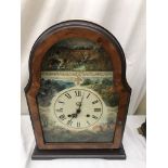 An American mantel clock with transferred dial in burr walnut effect case.