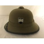 A modern German WWII-style pith helmet and military baseball caps