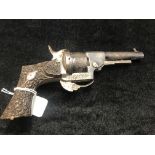 A 19th century ornate carved grip pin fire six-shot pistol: double action