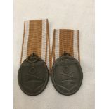 Two original West Wall medals and packets