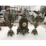 A modern brass clock garniture