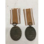 Two original West Wall medals and packets