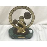 Devon Clocks Ltd: a mystery circulator revolving weight mystery clock set on a serpentine base: