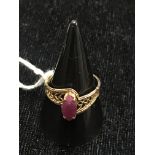 A 10k marquise ruby cut ring