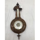 An oak carved barometer,