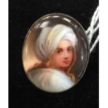 A miniature hand-painted brooch after Guido Reni