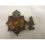 A WWII tropical Royal Marines helmet badge with POW feathers;