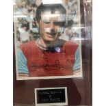 A framed & glazed signed photograph of Trevor Brooking with COA