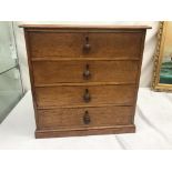 An oak miniature chest of drawers