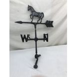 A meta weather vane in the form of a horse