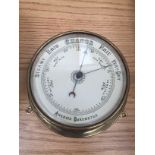 A brass aneroid barometer