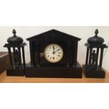 A black slate clock garniture