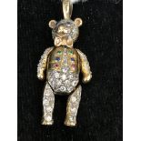 An articulated stone set gold bear pendant