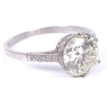 A Platinum Diamond Solitaire Ring: The old brilliant cut diamond spreading at over 2.