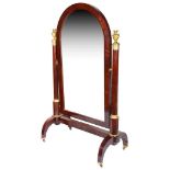 An Empire Period Cheval Mirror: The arched mahogany mirror suspended between rounded pillars