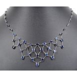 A 14ct White Gold Sapphire Necklace: 14ct white gold necklace set in frill pattern with oval cut