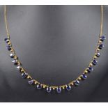 An 18ct Sapphire and Diamond Necklace: 18 oval cut sapphires interspersed with diamonds between