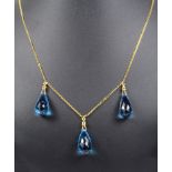 An 18ct Briolette Topaz and Diamond Necklace: Three large briolette cut blue topaz with diamonds