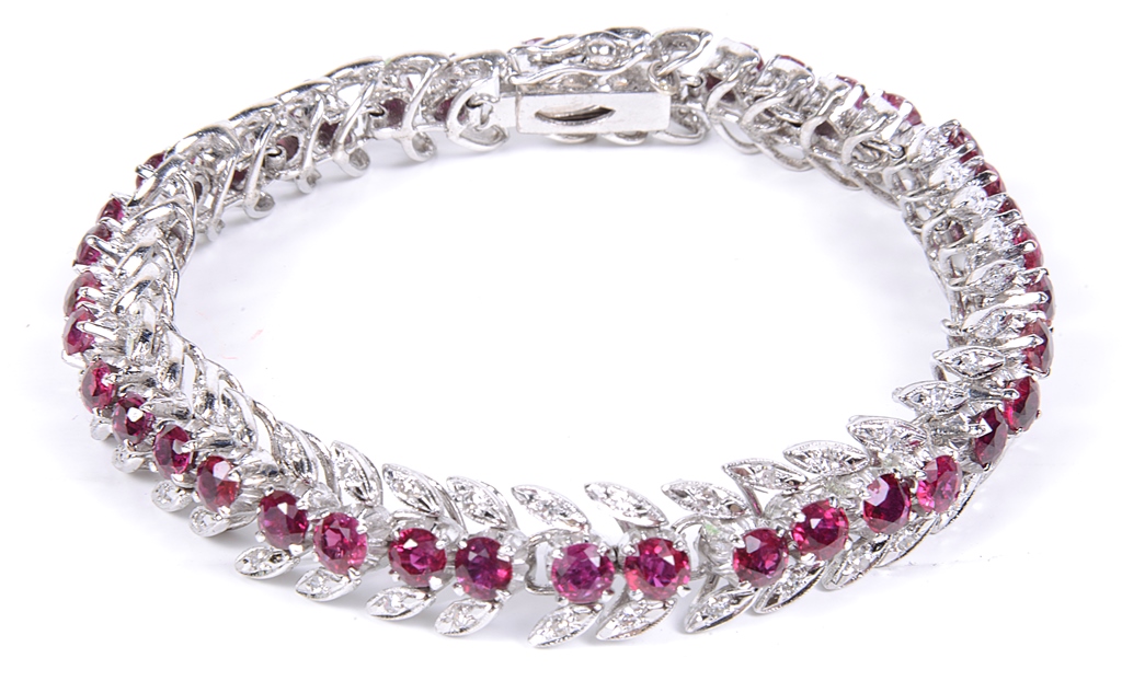 An Articulated Diamond and Ruby Bracelet: The bracelet in the form of diamond set leaves and a